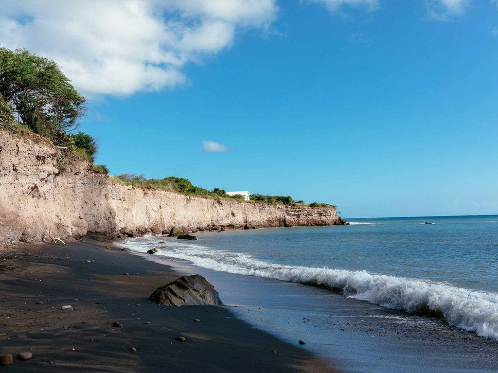 Landscape image of ocean and cliff.