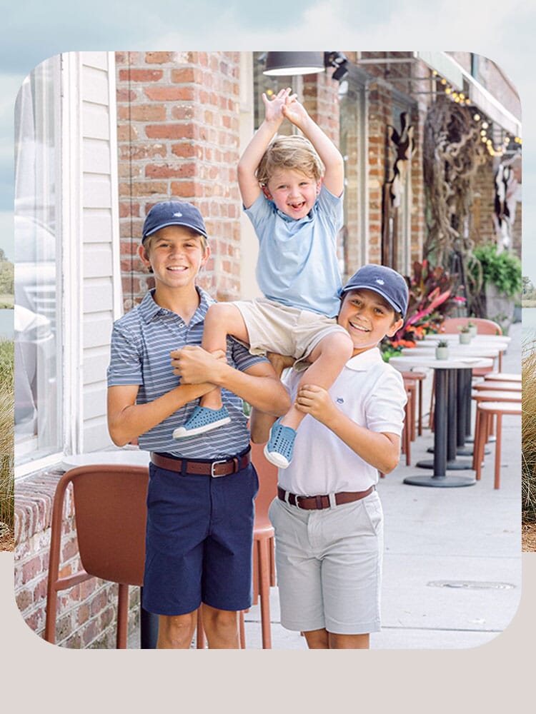 Three boy siblings wearing preppy youth apparel downtown to get ice cream