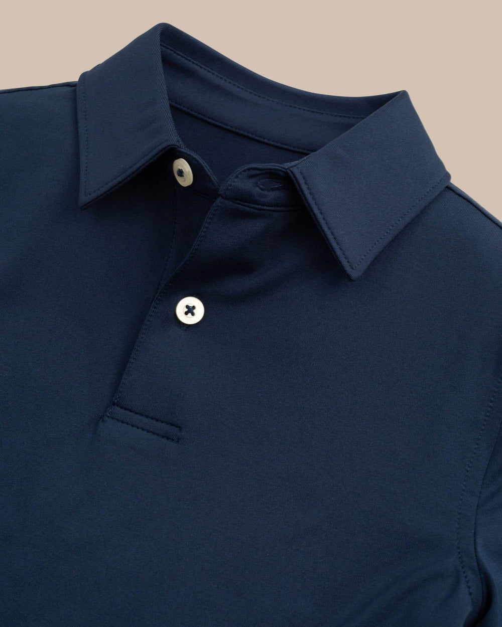 The detail view of the Boys Driver Performance Polo Shirt by Southern Tide - True Navy
