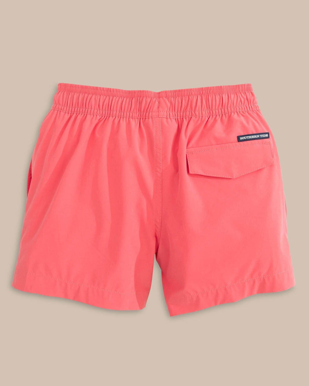 The back view of the Southern Tide Boys Solid Swim Truck 2 0 by Southern Tide - Sunkist Coral