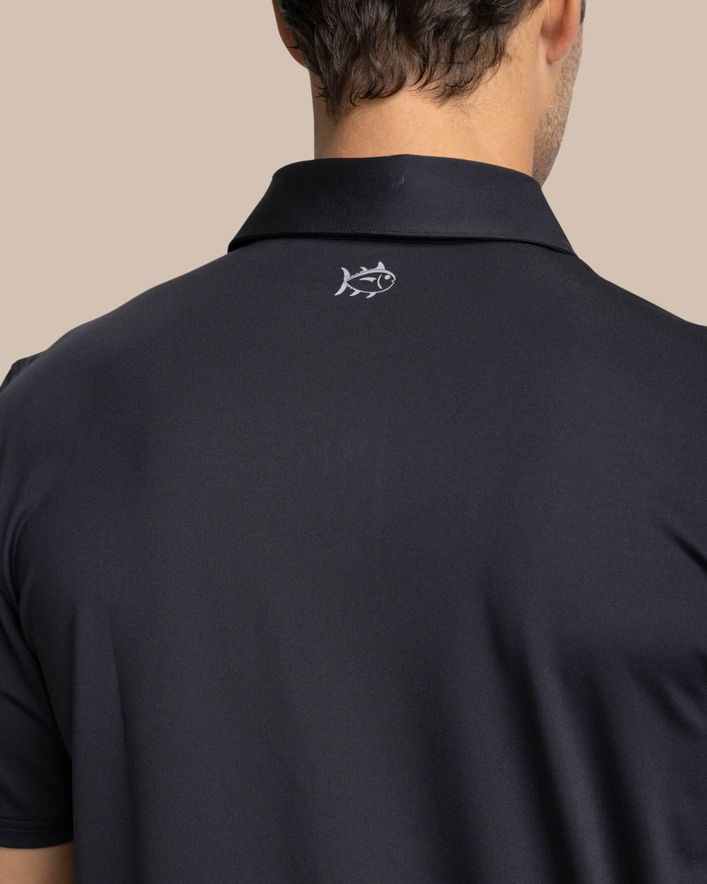 The detail view of the Southern Tide Brenton Chest Stripe Performance Polo by Southern Tide - Black