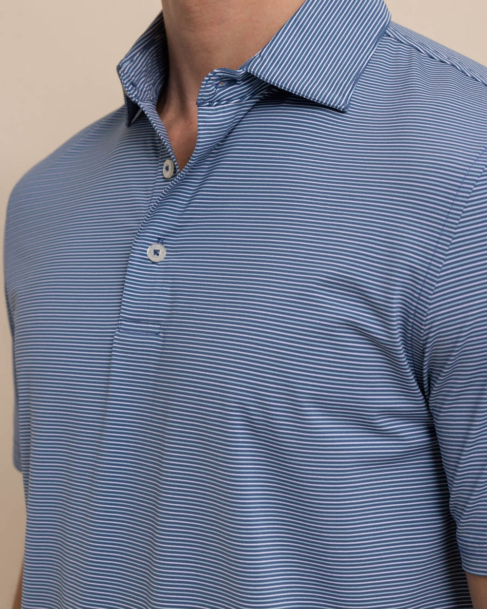 The detail view of the Southern Tide brrr-eeze Baytop Stripe Performance Polo by Southern Tide - Aged Denim