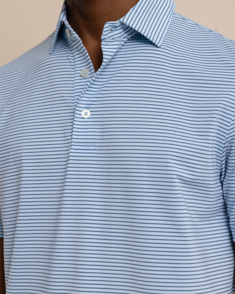 The detail view of the Southern Tide brrr-eeze Baytop Stripe Performance Polo by Southern Tide - Clearwater Blue