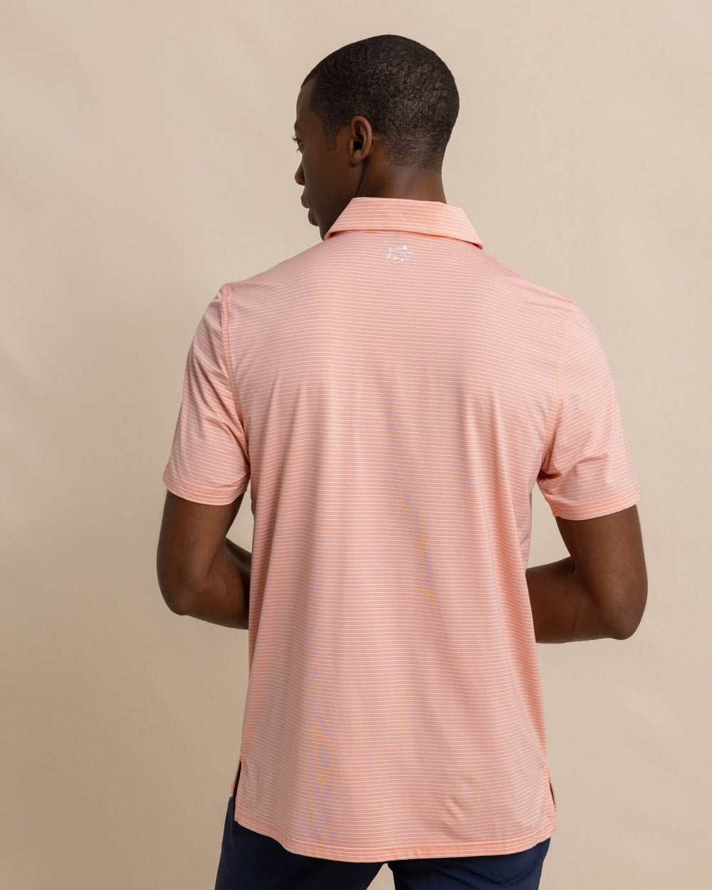 The back view of the Southern Tide brrr-eeze Baytop Stripe Performance Polo by Southern Tide - Desert Flower Coral