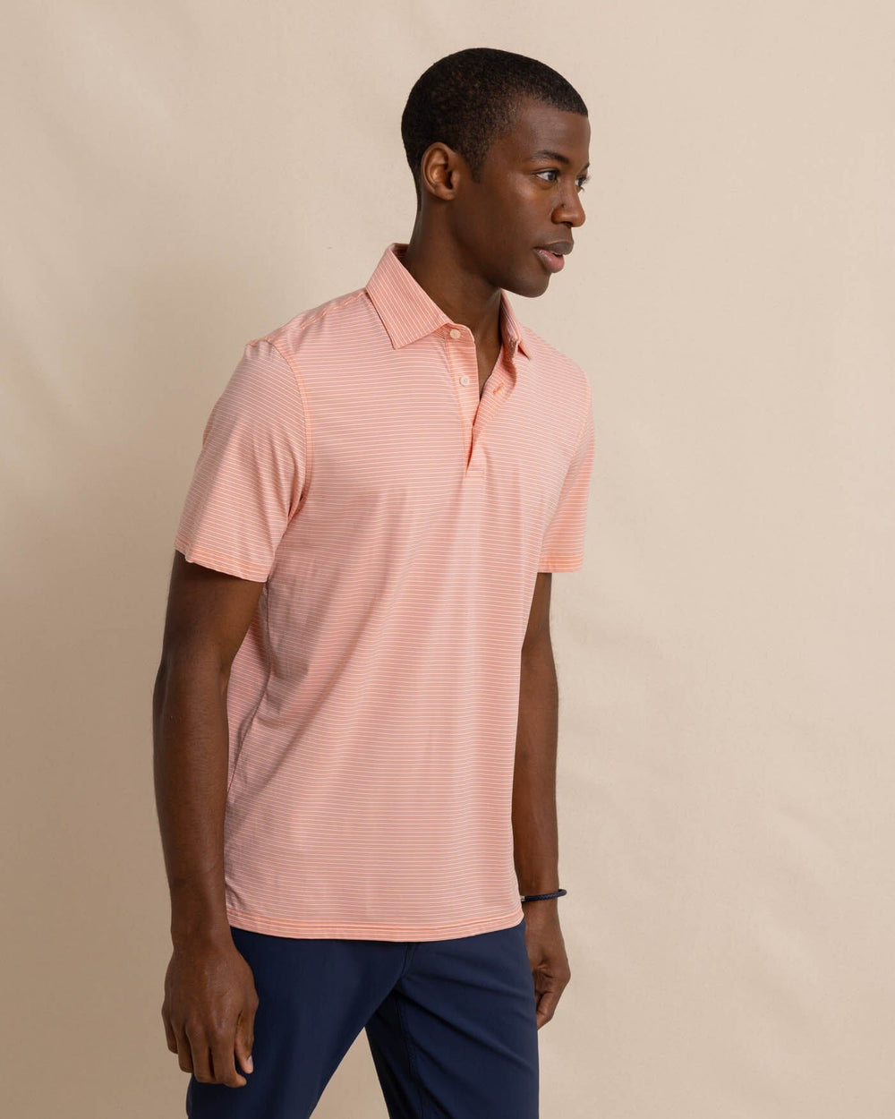 The front view of the Southern Tide brrr-eeze Baytop Stripe Performance Polo by Southern Tide - Desert Flower Coral