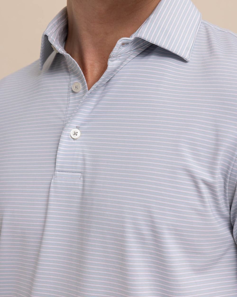 The detail view of the Southern Tide brrr-eeze Baytop Stripe Performance Polo by Southern Tide - Platinum Grey