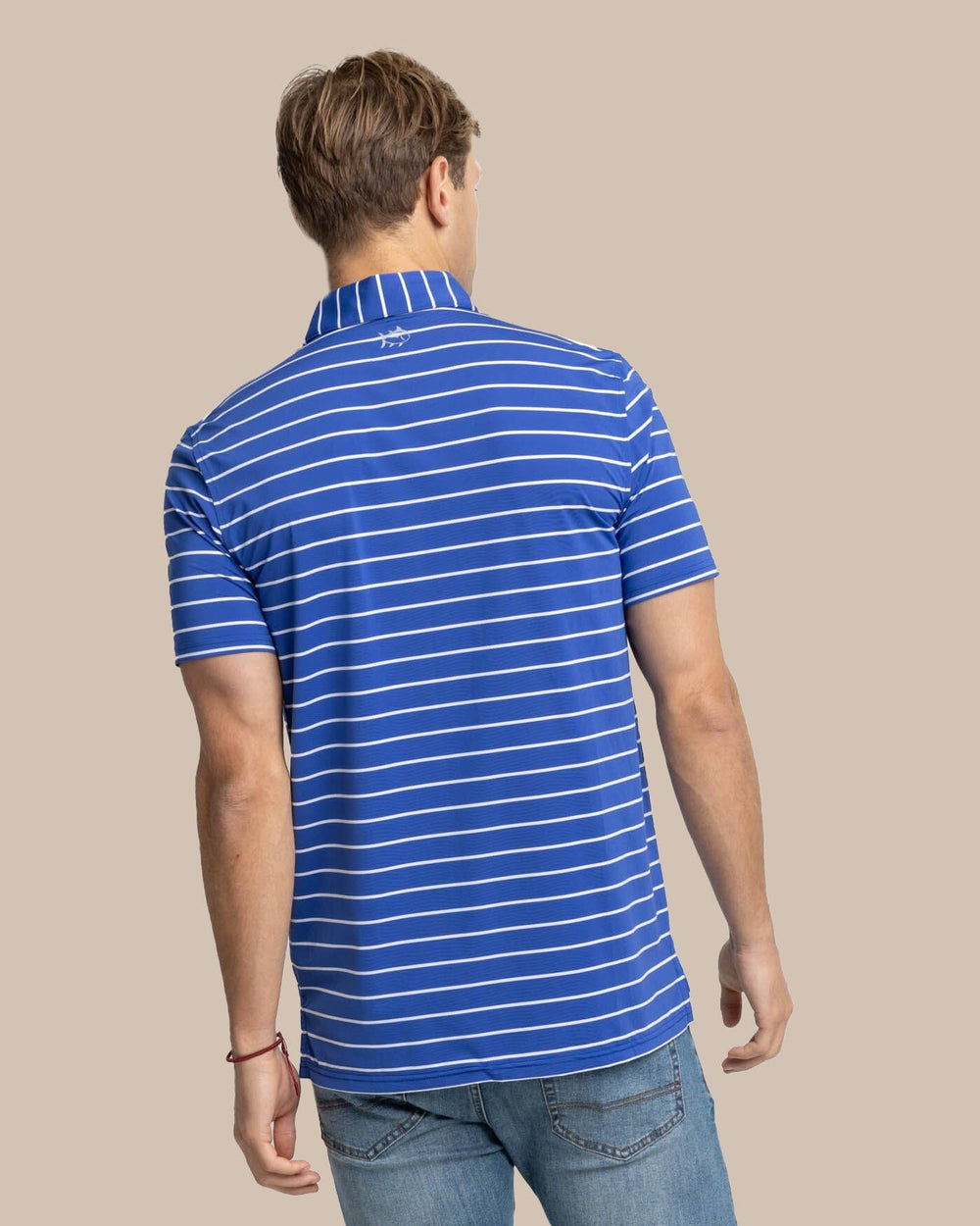 The back view of the Southern Tide brrr-eeze Desmond Stripe Performance Polo by Southern Tide - University Blue