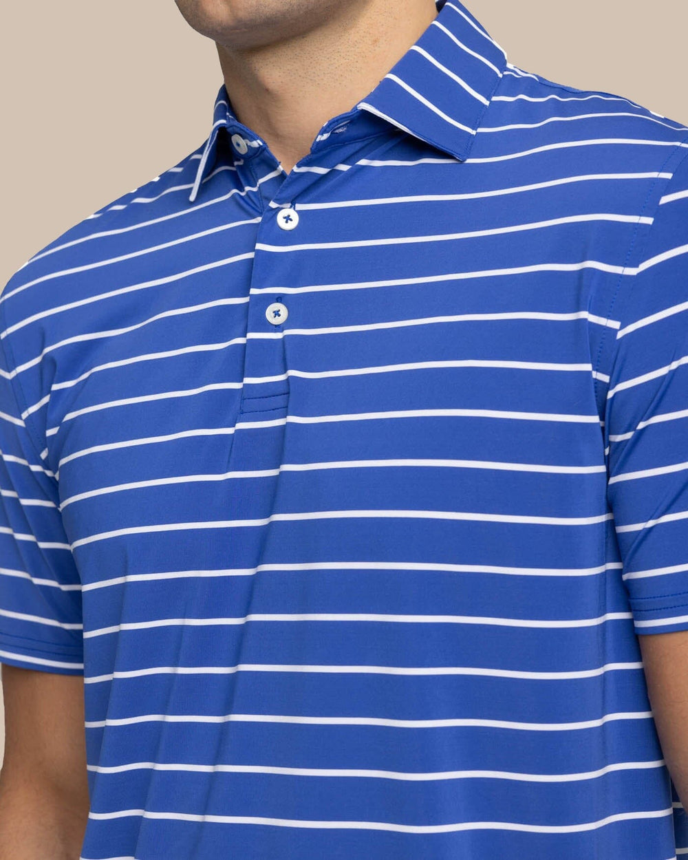 The detail view of the Southern Tide brrr-eeze Desmond Stripe Performance Polo by Southern Tide - University Blue