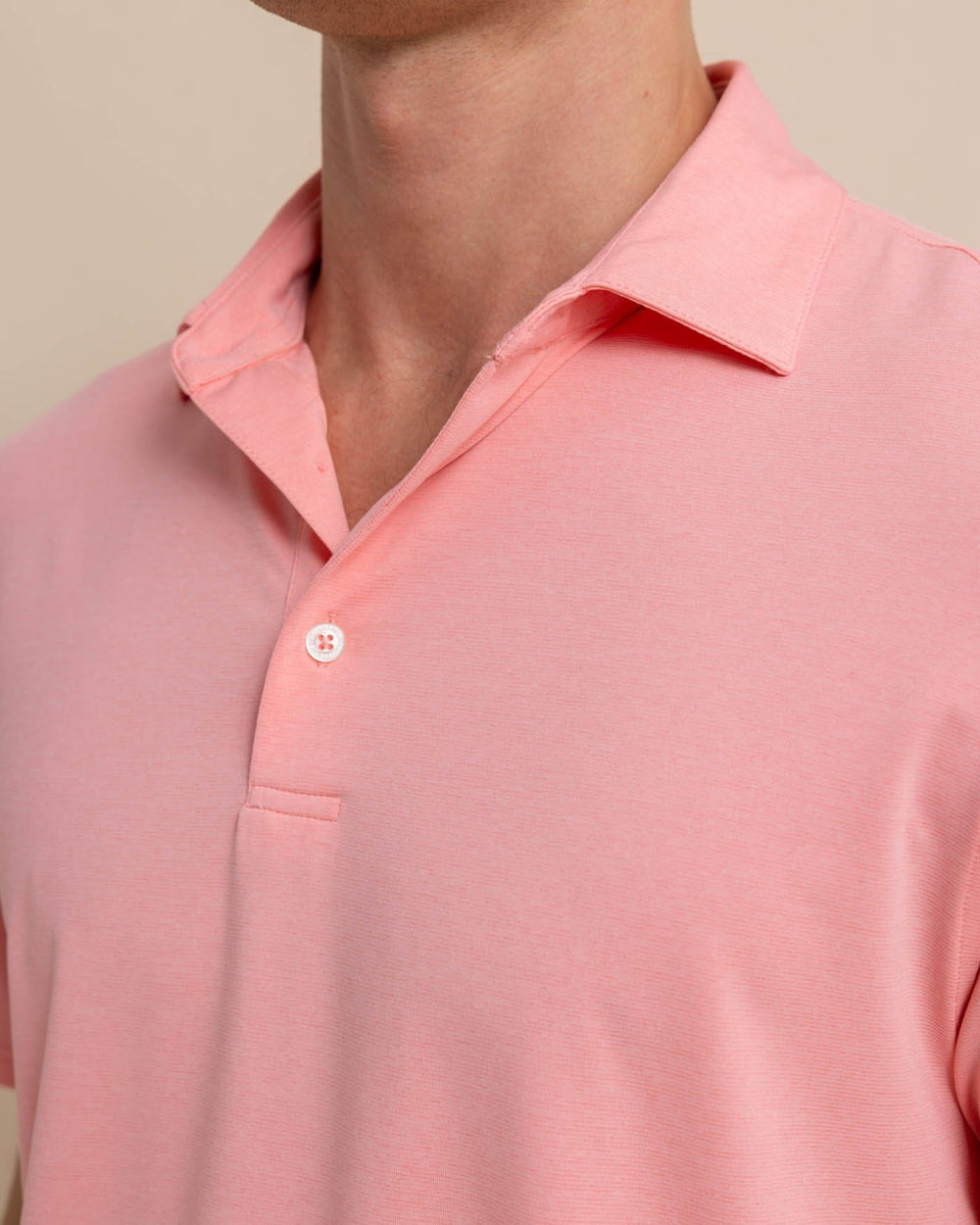 The detail view of the Southern Tide brrr-eeze-heather-performance-polo-shirt by Southern Tide - Heather Flamingo Pink