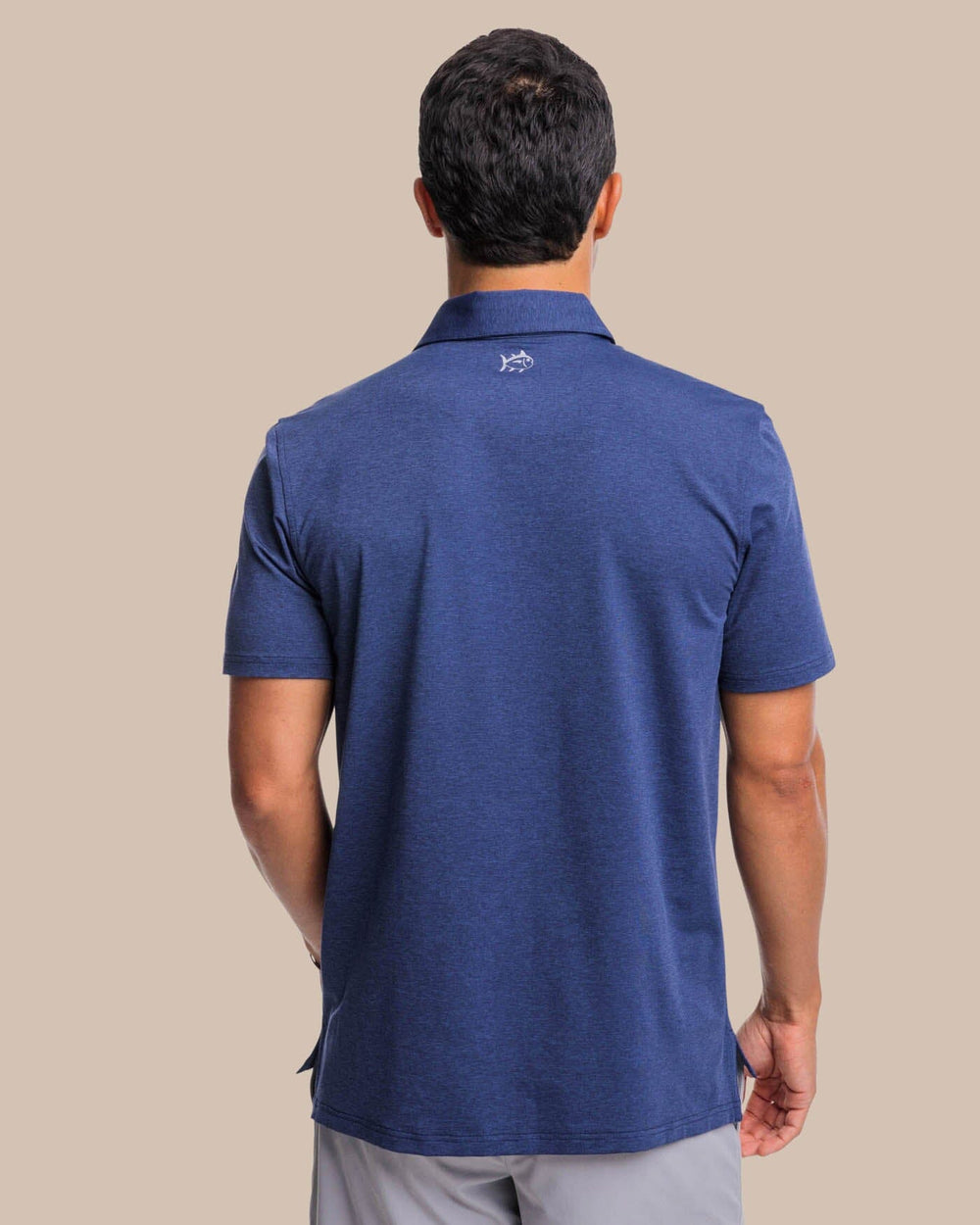The back view of the brrr°®-eeze Heather Performance Polo Shirt by Southern Tide - Heather Nautical Navy