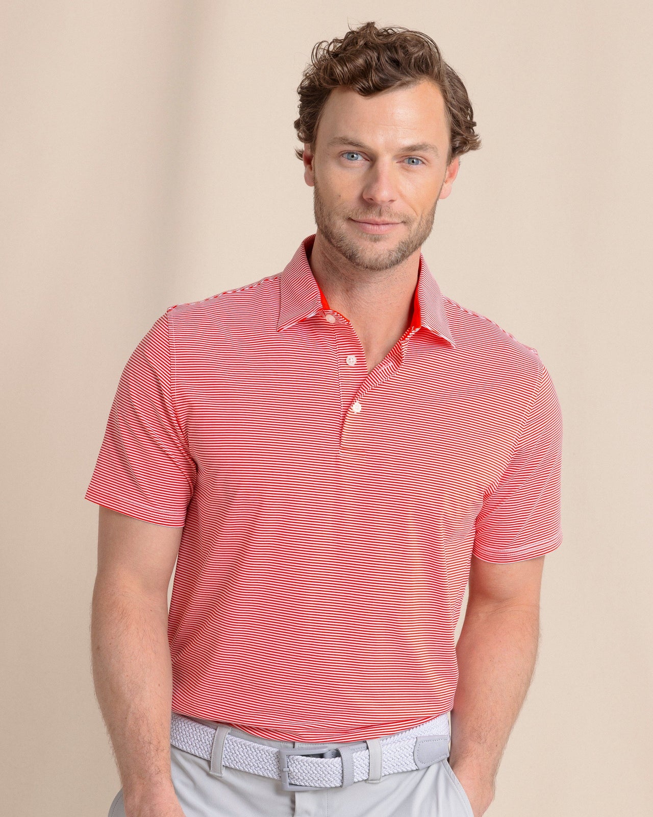 The front view of the Southern Tide brrr°®-eeze Meadowbrook Stripe Polo by Southern Tide - Poppy Red