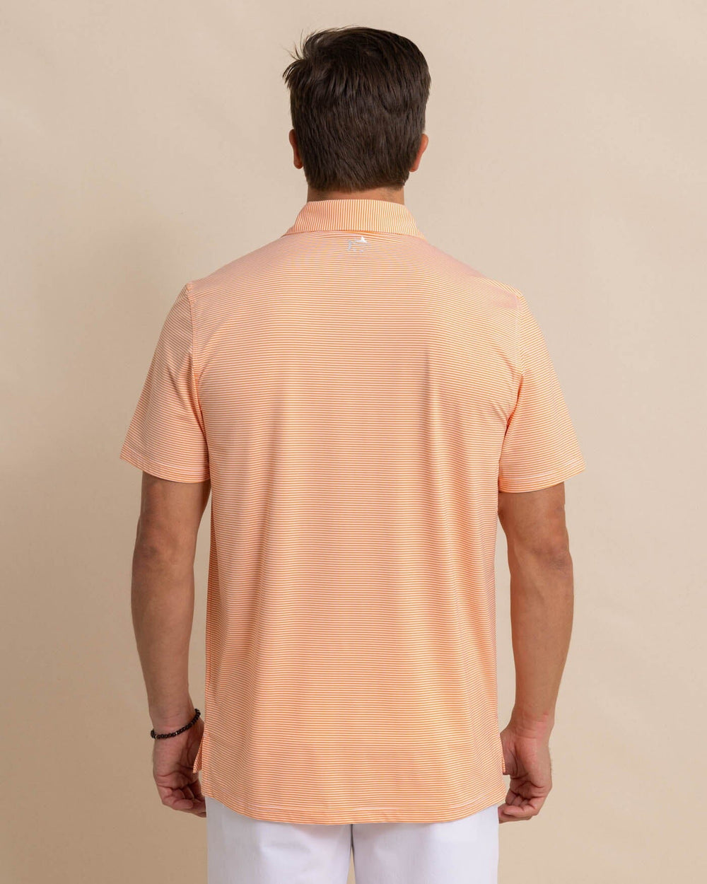 The back view of the Southern Tide brrr-eeze-meadowbrook-stripe-polo by Southern Tide - Tangerine Orange