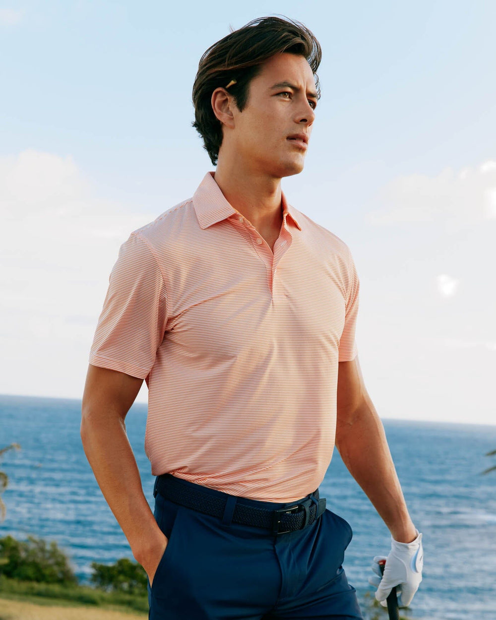 The front view of the Southern Tide brrr-eeze-meadowbrook-stripe-polo by Southern Tide - Tangerine Orange