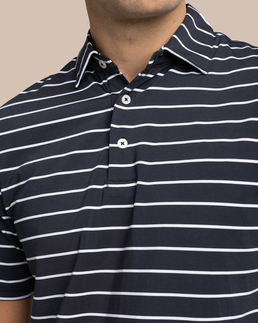 The detail view of the Southern Tide brrr-eeze Desmond Stripe Performance Polo by Southern Tide - Black
