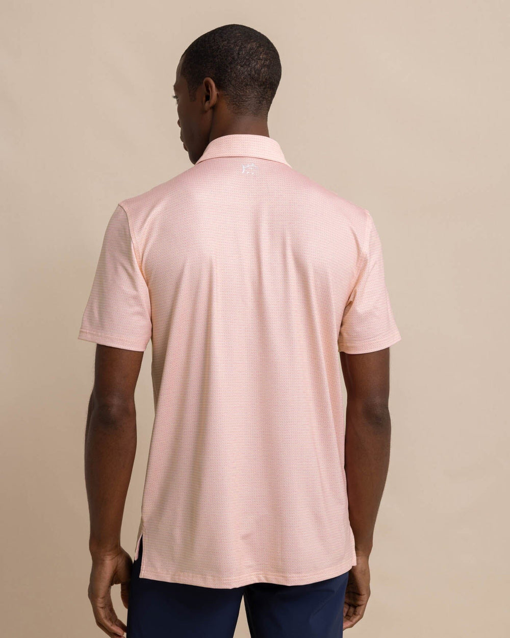 The back view of the Southern Tide Driver Getting Ziggy With It Printed Polo by Southern Tide - Apricot Blush Coral