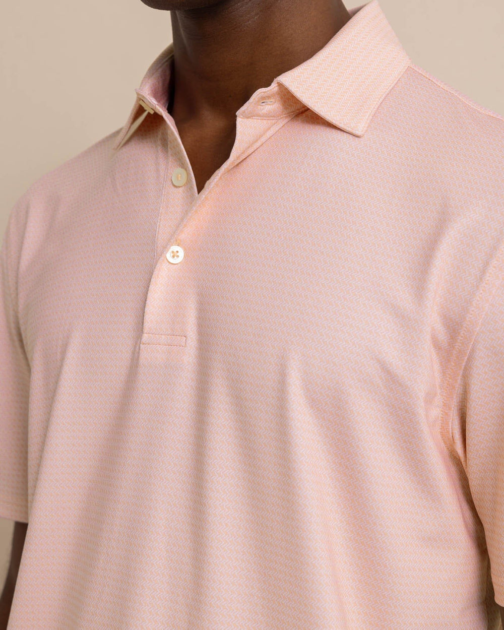 The detail view of the Southern Tide Driver Getting Ziggy With It Printed Polo by Southern Tide - Apricot Blush Coral