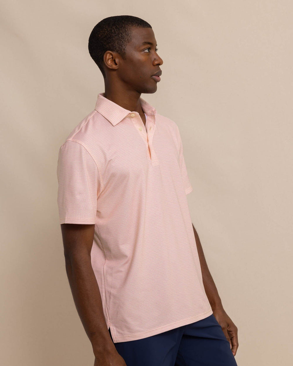 The front view of the Southern Tide Driver Getting Ziggy With It Printed Polo by Southern Tide - Apricot Blush Coral