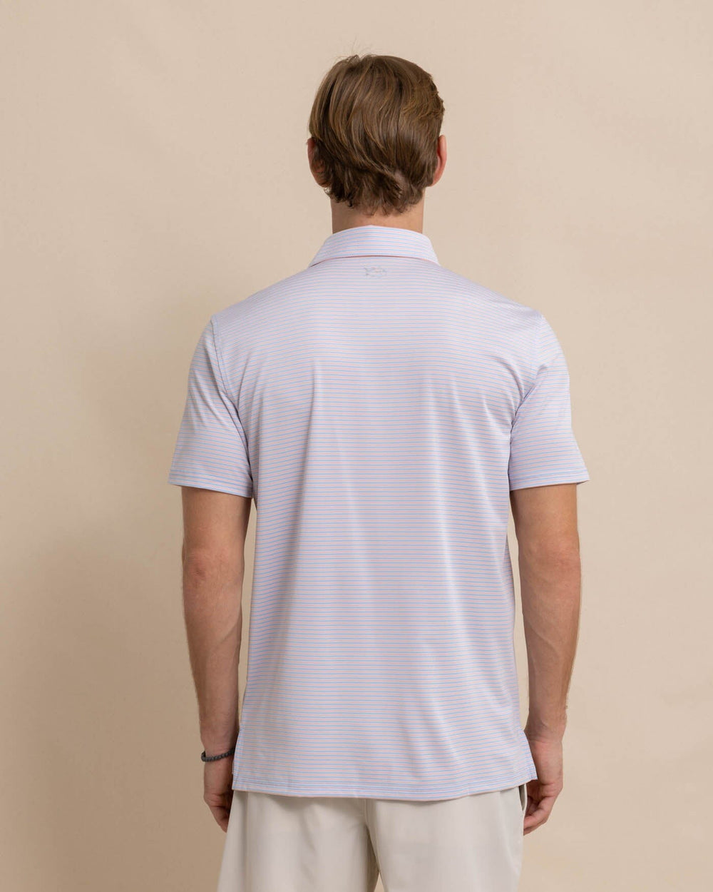 The back view of the Southern Tide Driver Verdae Stripe Polo by Southern Tide - Apricot Blush Coral