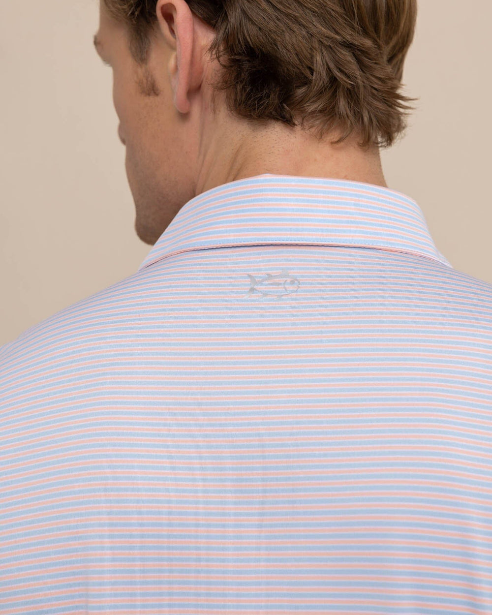 The detail view of the Southern Tide Driver Verdae Stripe Polo by Southern Tide - Apricot Blush Coral