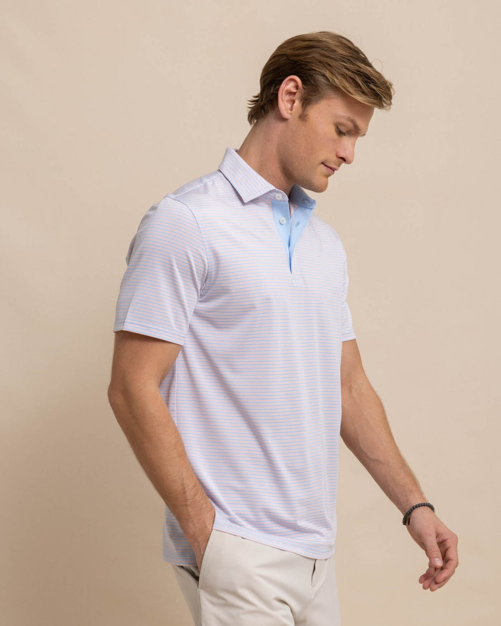 The front view of the Southern Tide Driver Verdae Stripe Polo by Southern Tide - Apricot Blush Coral