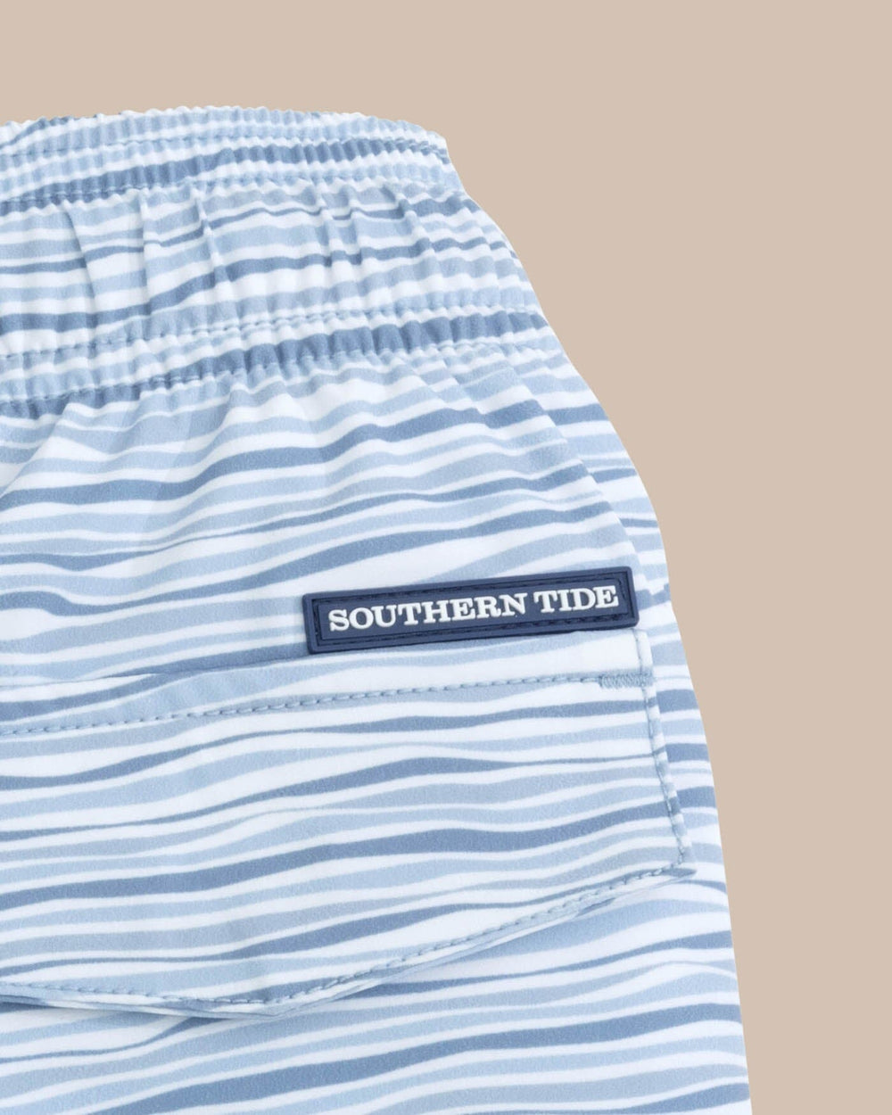 The detail view of the Southern Tide Kids Ocean Water Stripe Swim Trunk by Southern Tide - Subdued Blue