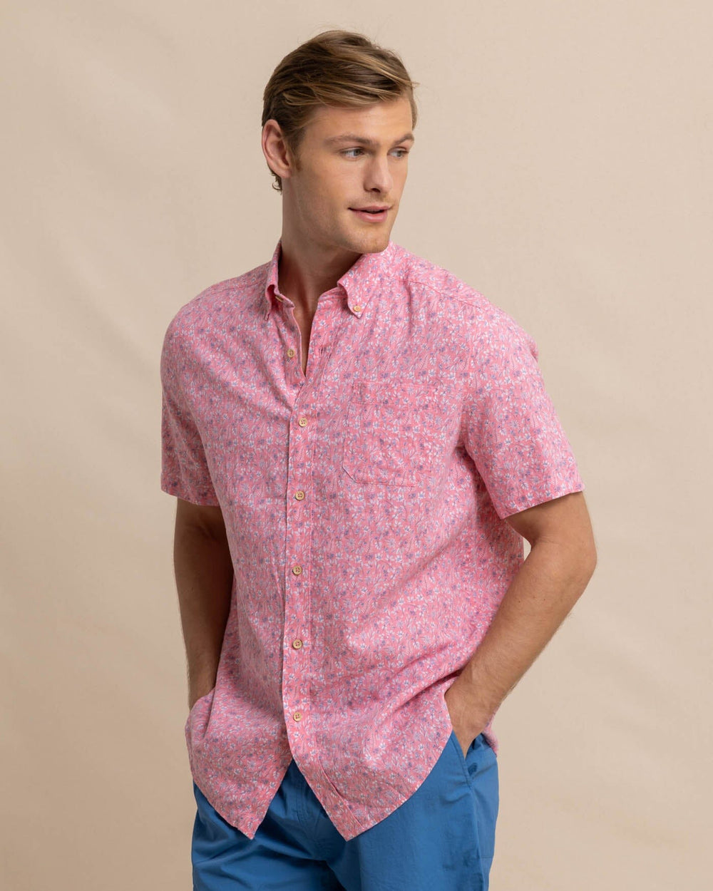 The front view of the Southern Tide Linen Rayon Ditzy Floral Short Sleeve Sport Shirt by Southern Tide - Geranium Pink