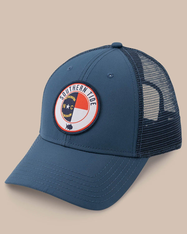 The front view of the Men's North Carolina Patch Performance Trucker Hat by Southern Tide - Seven Seas Blue