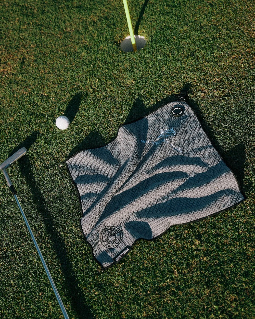 The laydown view of the Southern Tide Ghost Golf Magnetic Towel by Southern Tide - Grey