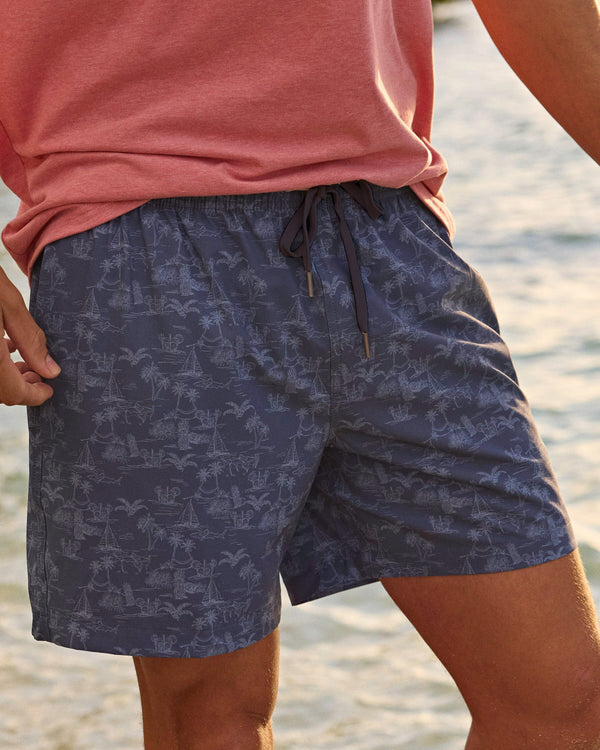 The lifestyle view of the Southern Tide Tide To The Shore Swim Trunk by Southern Tide - Light Indigo