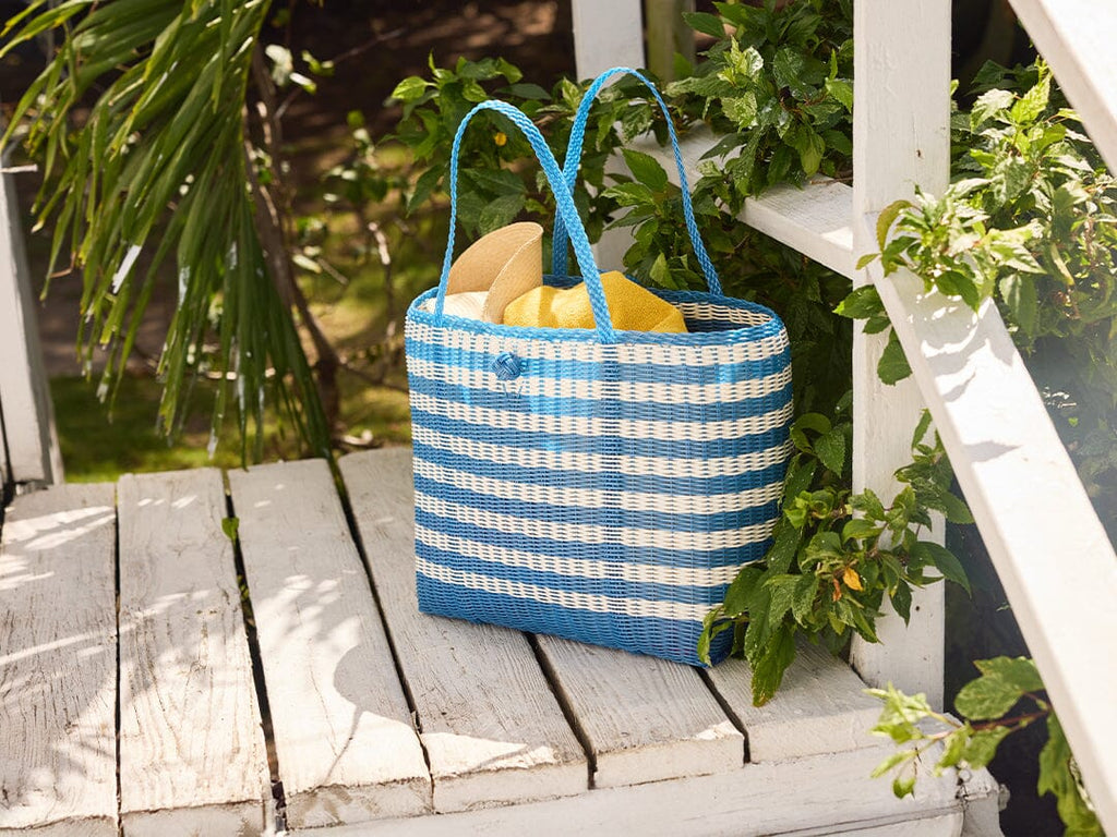 Woven blue and white tote bag on deck.