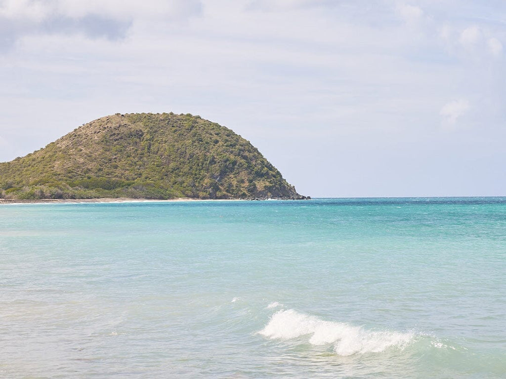 Man and woman on paddle board in the ocean.