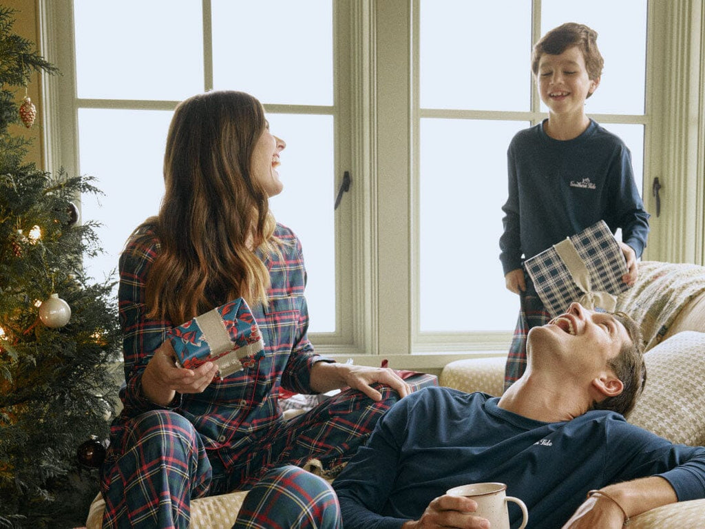 Family on a boat wearing matching Christmas pajamas.