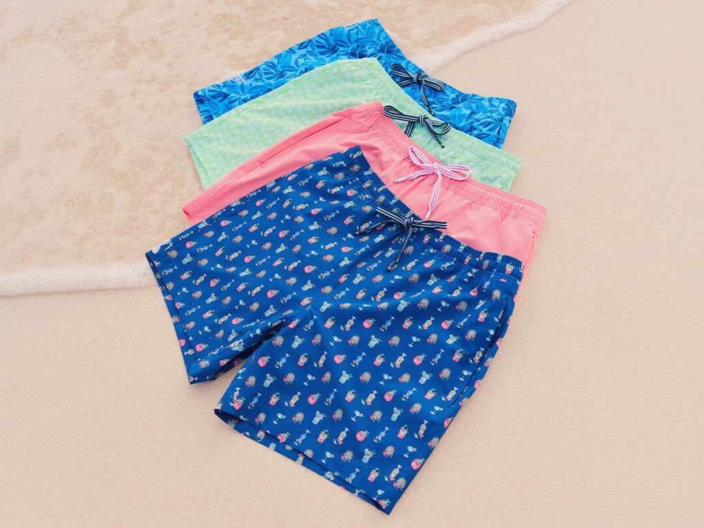 Lay down image of men's swim trunks on beach.