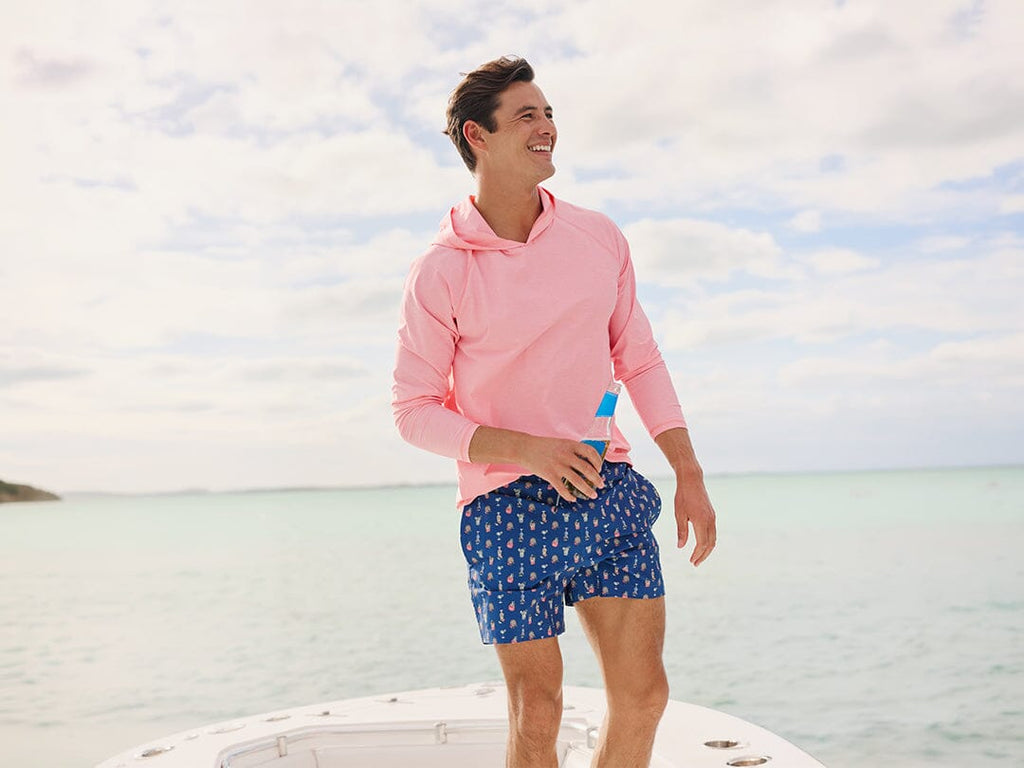 Man wearing Beach Flannel outside holding a bag.