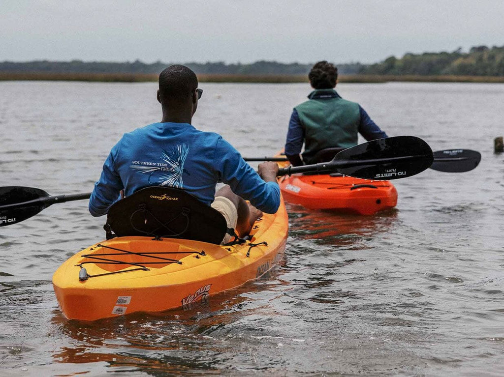 Two men kayaking in a river. 