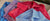 Four men's polo shirts stacked featuring striped and solid colors.