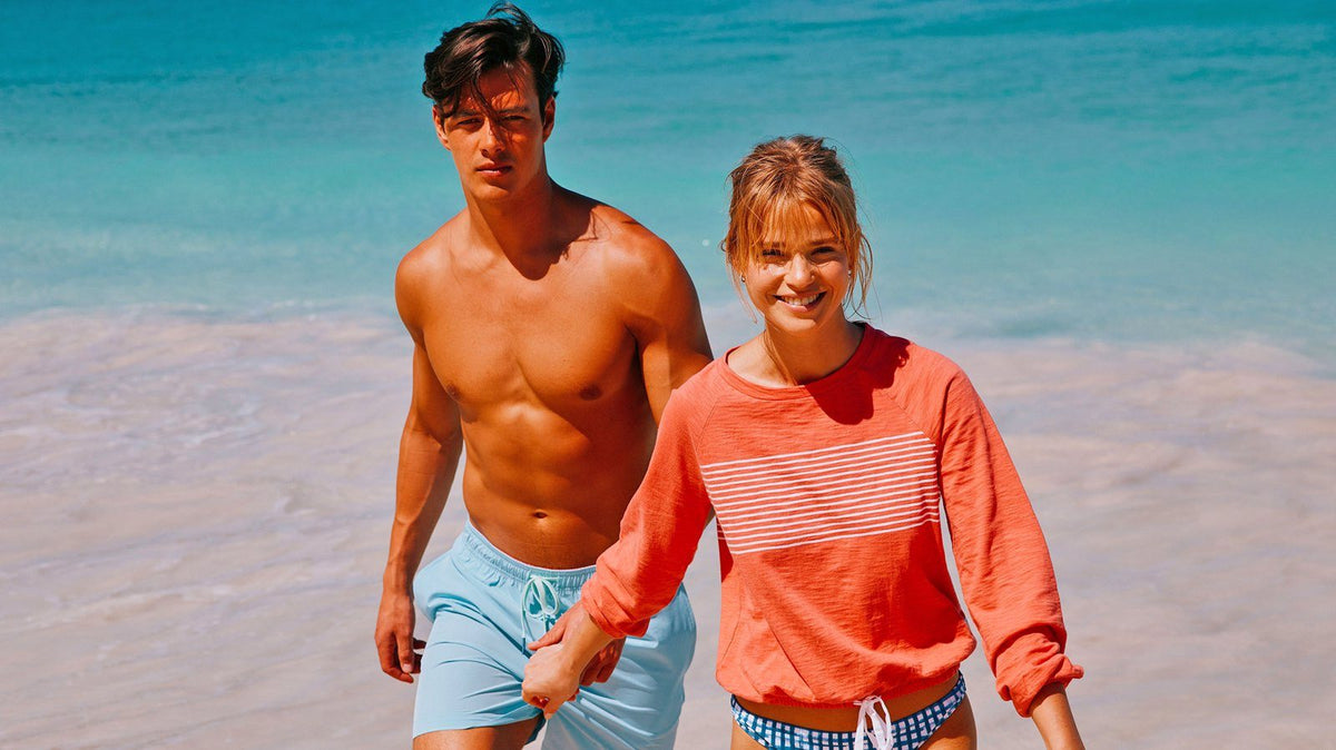 man and woman walking out of the ocean together