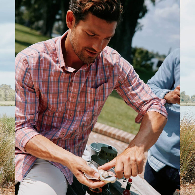 Men's Fall New Arrivals - man shucking oyster at outdoor bbq