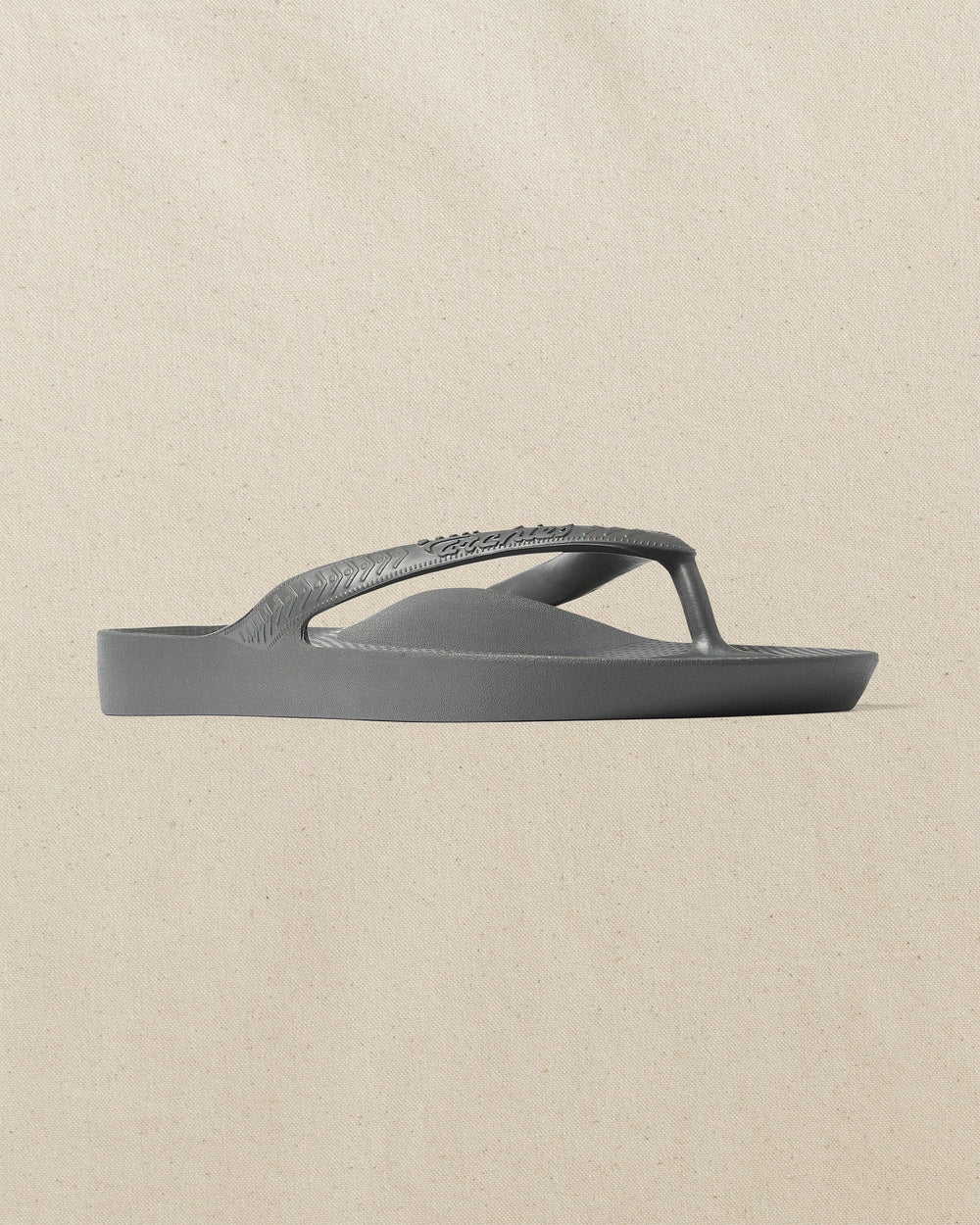 The front side view of the Southern Tide Archie's Charcoal Arch Support Flip Flop by Southern Tide - Charcoal