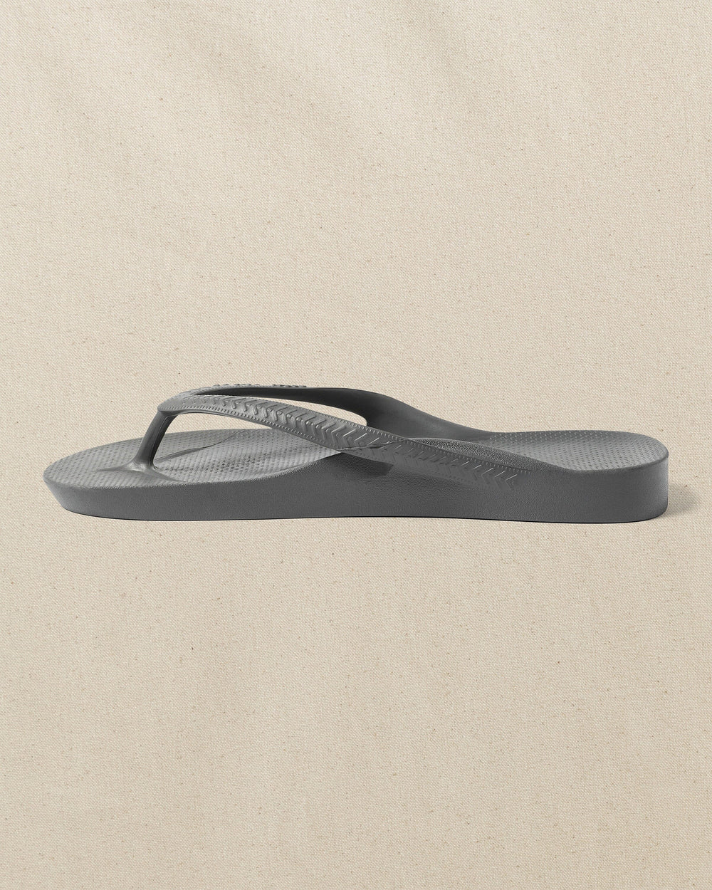 The left side view of the Southern Tide Archie's Charcoal Arch Support Flip Flop by Southern Tide - Charcoal