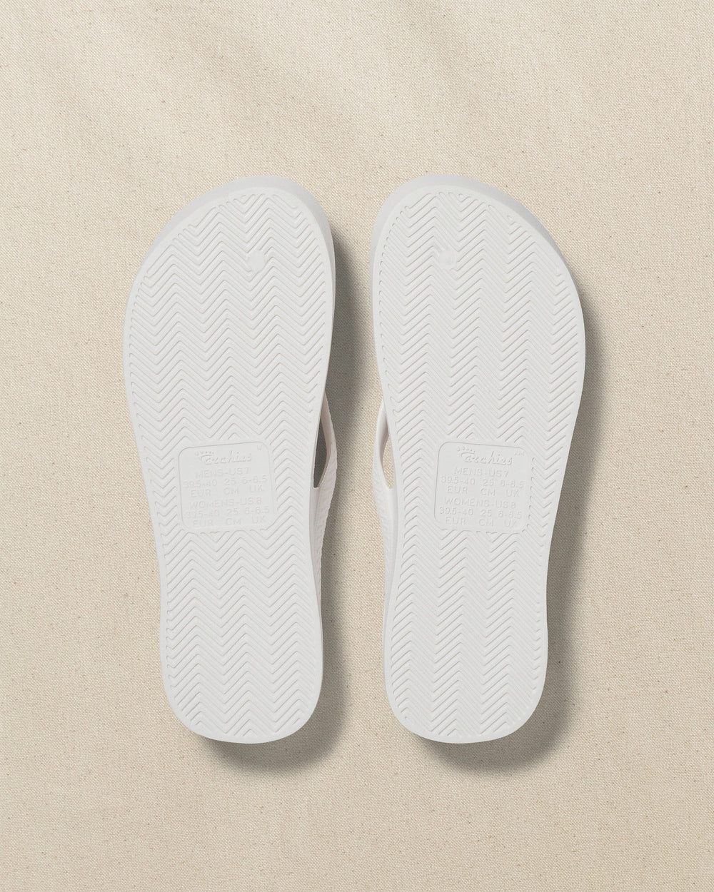 The bottom view of the Southern Tide Archies Classic White Arch Support Flip Flop by Southern Tide - Classic White