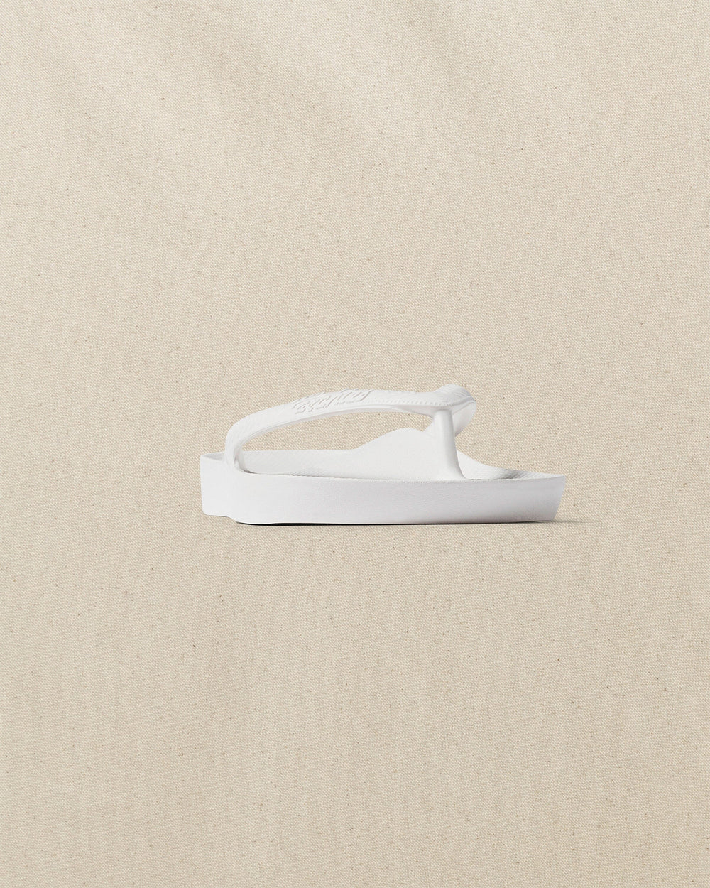 The front side view of the Southern Tide Archies Classic White Arch Support Flip Flop by Southern Tide - Classic White