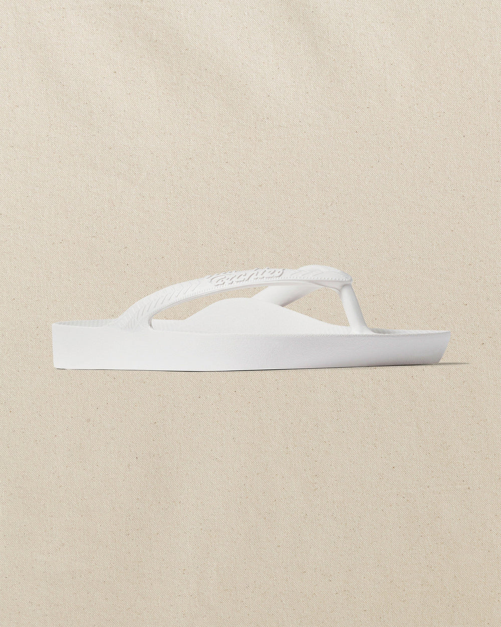 The right angle view of the Southern Tide Archies Classic White Arch Support Flip Flop by Southern Tide - Classic White