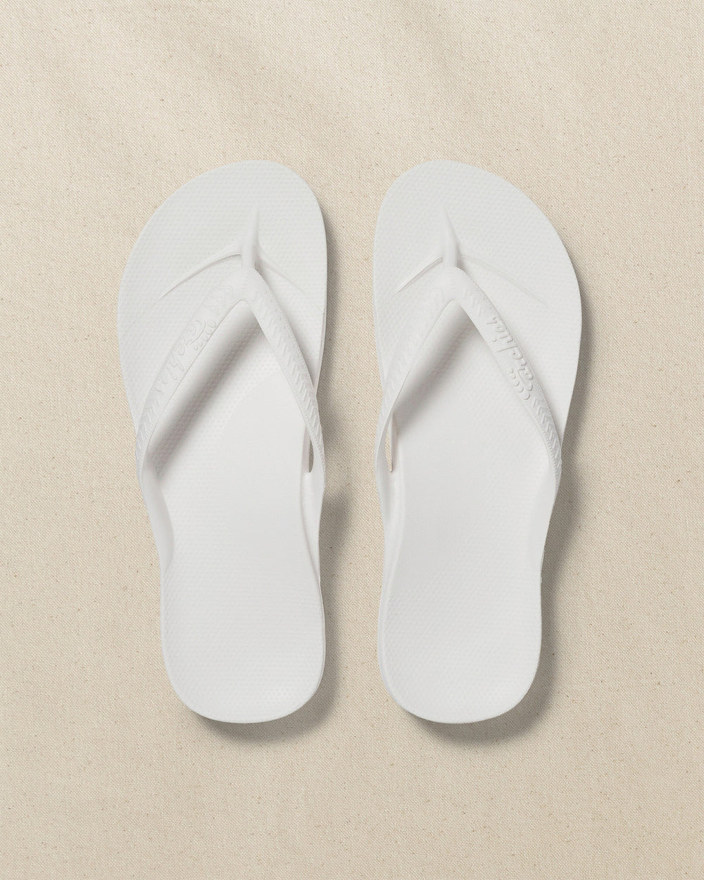 The top view of the Southern Tide Archies Classic White Arch Support Flip Flop by Southern Tide - Classic White