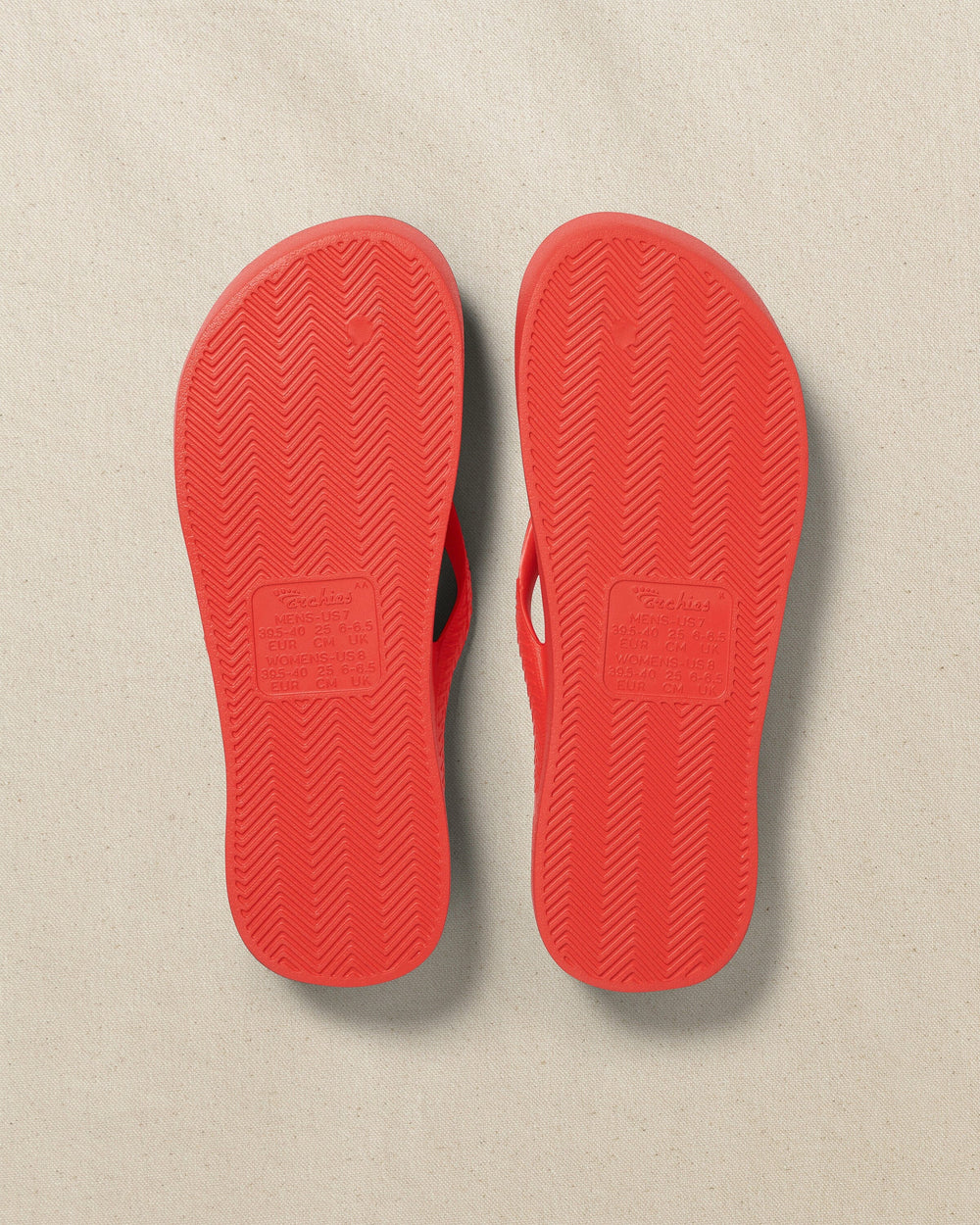 The bottom view of the Southern Tide Archie's Coral Arch Support Flip Flop by Southern Tide - Coral