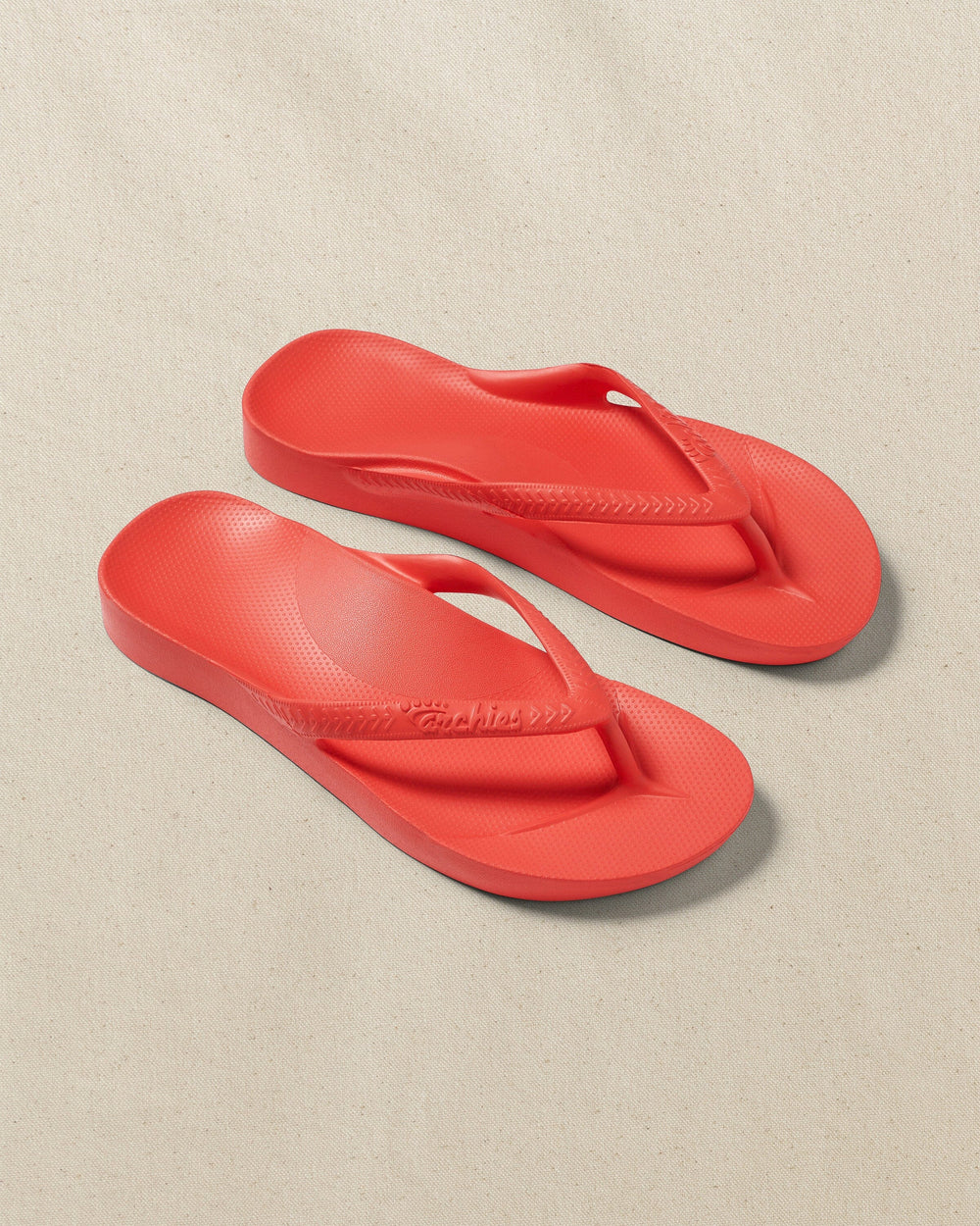 The front view of the Southern Tide Archie's Coral Arch Support Flip Flop by Southern Tide - Coral