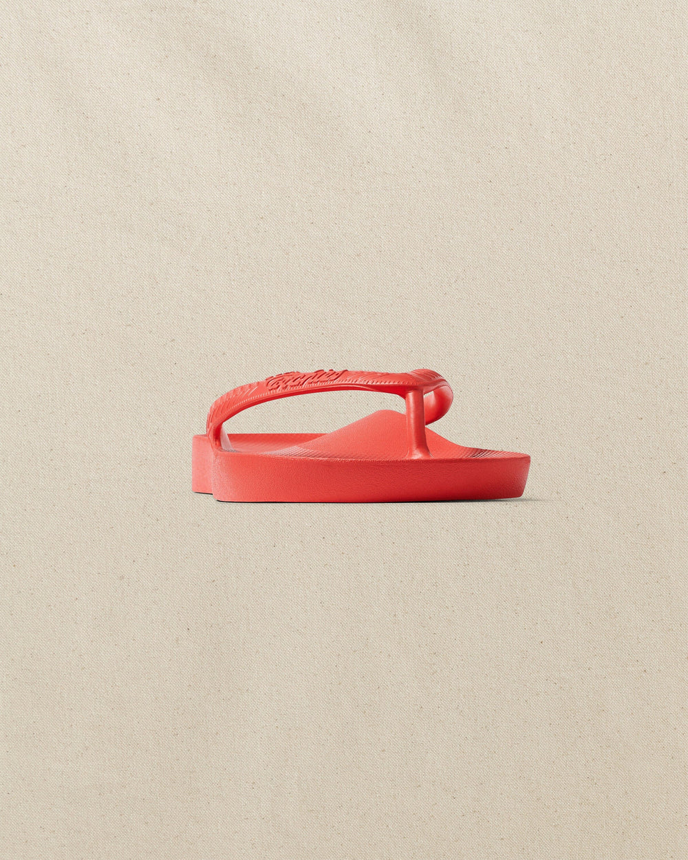 The front side view of the Southern Tide Archie's Coral Arch Support Flip Flop by Southern Tide - Coral