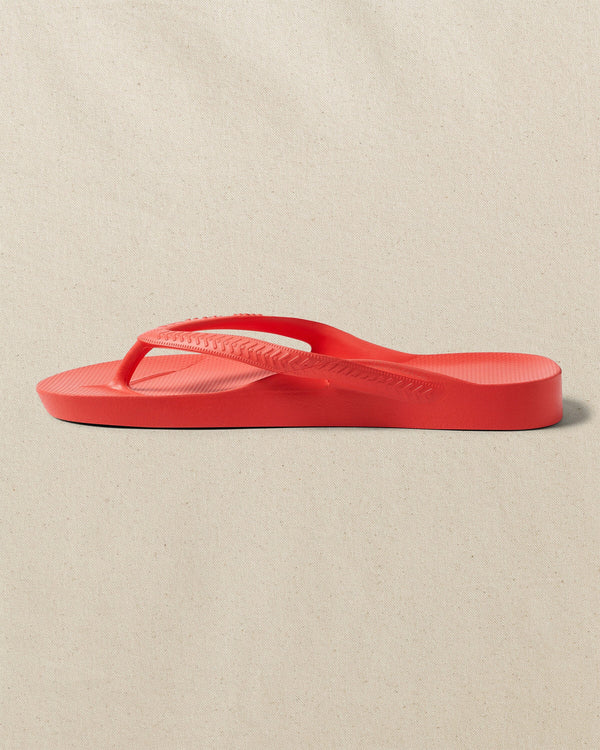 The left side view of the Southern Tide Archie's Coral Arch Support Flip Flop by Southern Tide - Coral