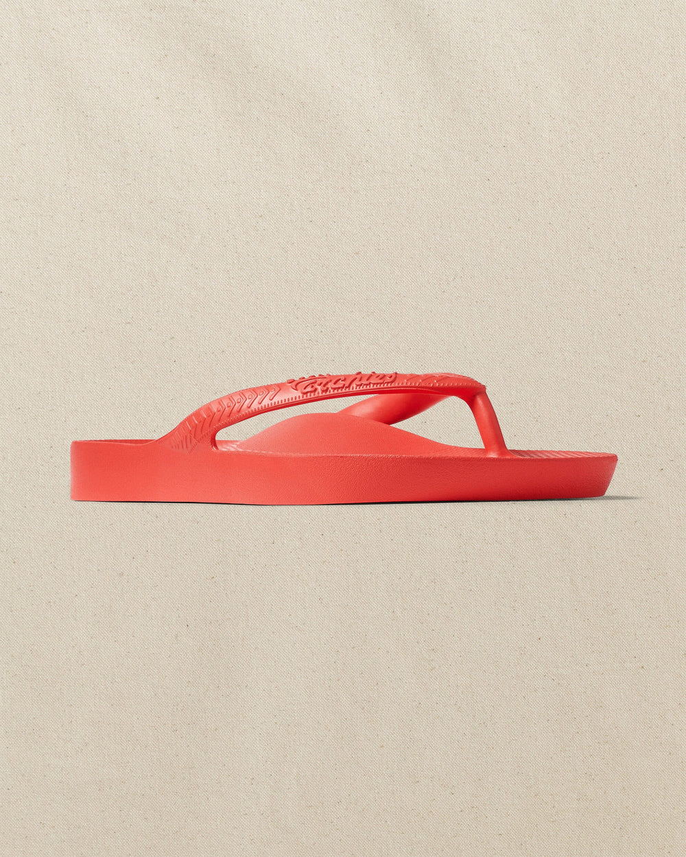 The right angle view of the Southern Tide Archie's Coral Arch Support Flip Flop by Southern Tide - Coral