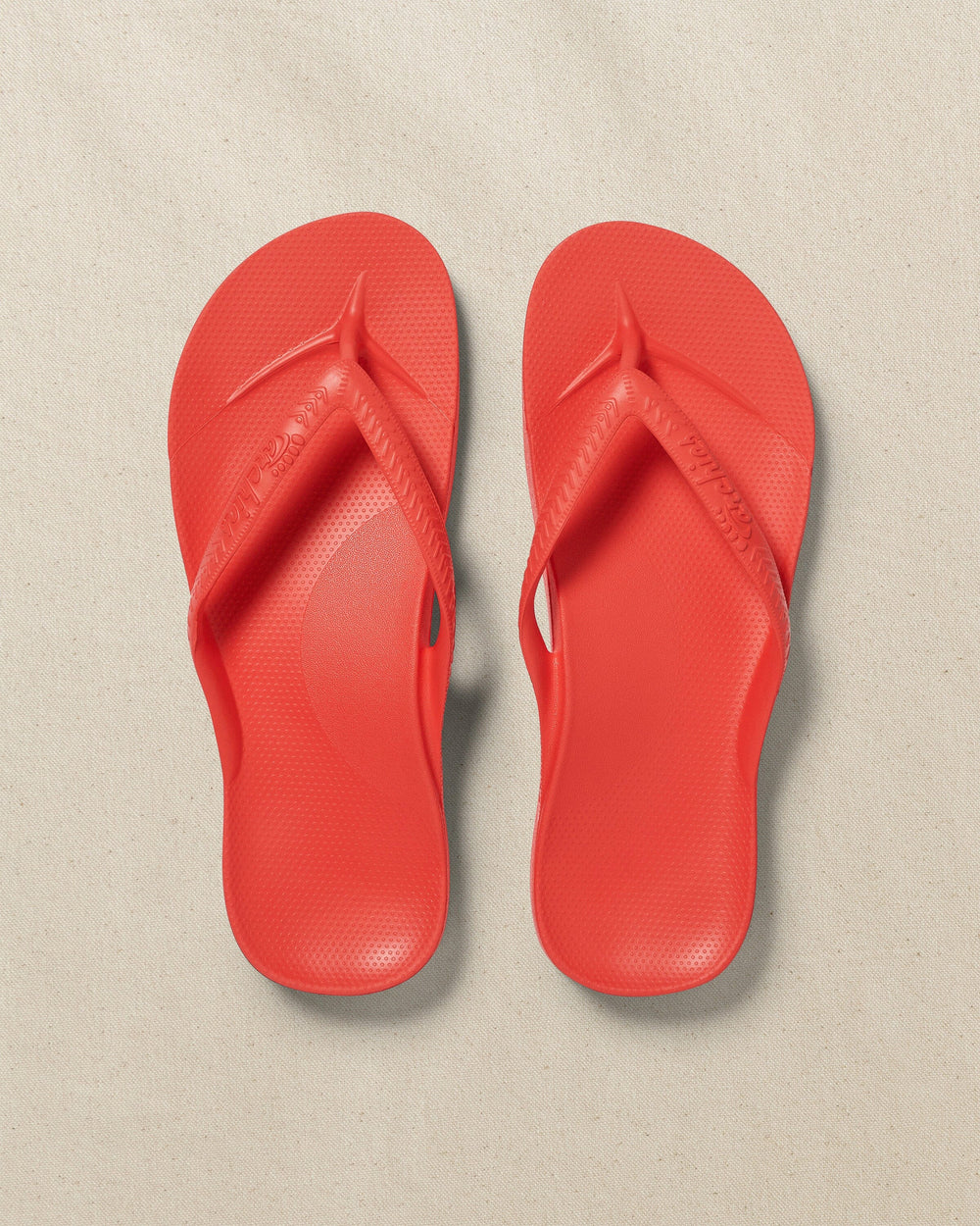 The top view of the Southern Tide Archie's Coral Arch Support Flip Flop by Southern Tide - Coral